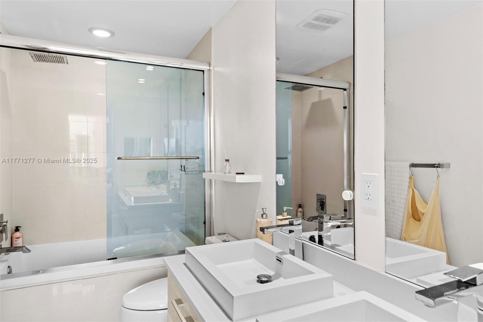 55 Southwest 9th Street, Unit 3601 Miami, FL 33130 - Photo 15 of 38 a bathroom with a sink toilet and shower