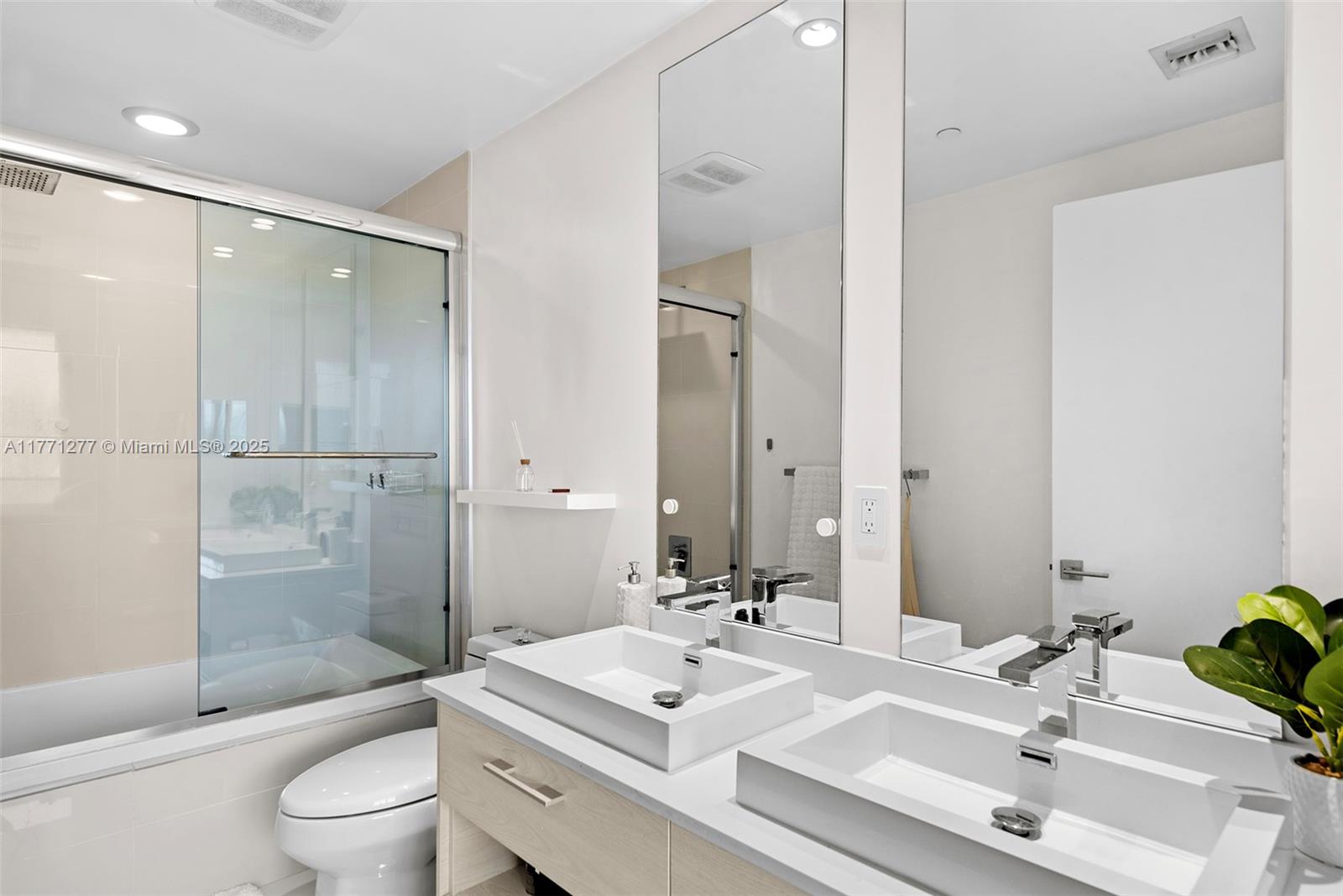 55 Southwest 9th Street, Unit 3601 Miami, FL 33130 - Photo 16 of 38 a bathroom with a sink toilet tub and shower