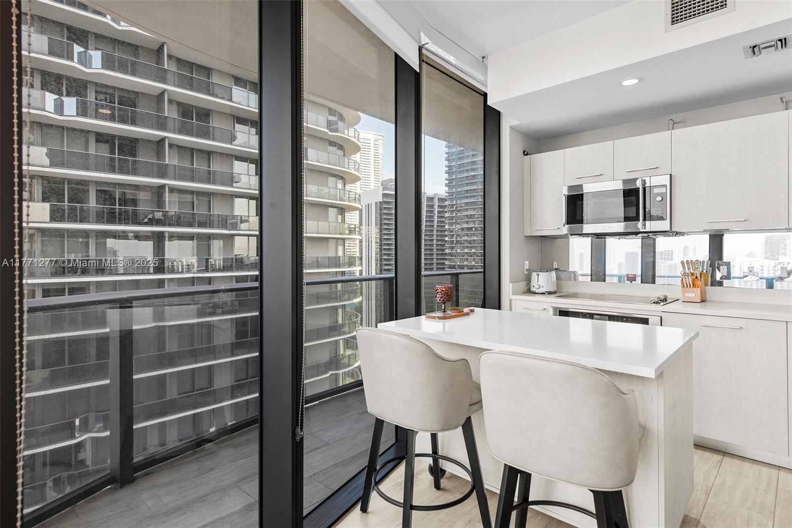 55 Southwest 9th Street, Unit 3601 Miami, FL 33130 - Photo 19 of 38 a dining room with furniture and a window