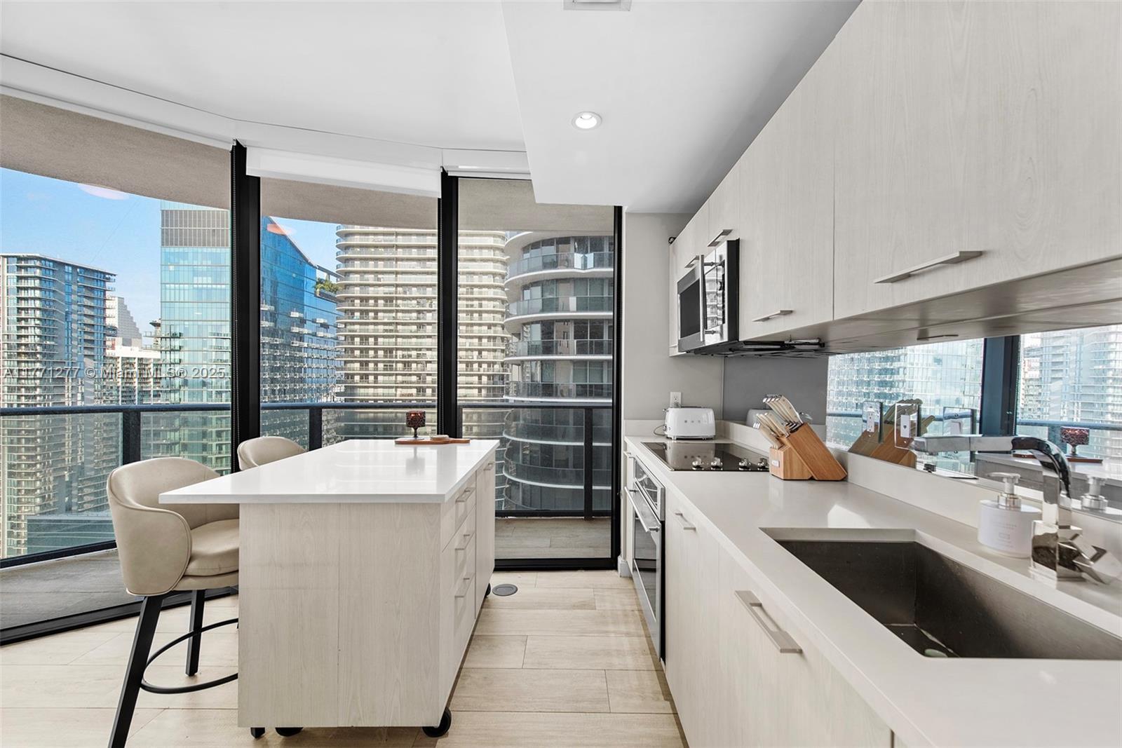 55 Southwest 9th Street, Unit 3601 Miami, FL 33130 - Photo 20 of 38 a kitchen with a sink stove top oven and cabinets