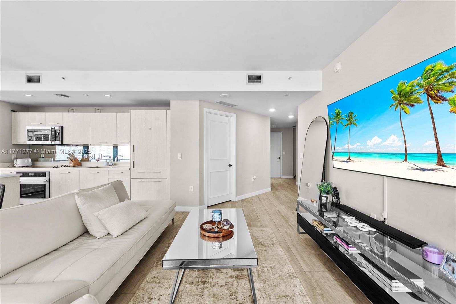 55 Southwest 9th Street, Unit 3601 Miami, FL 33130 - Photo 2 of 38 a living room with furniture and a rug