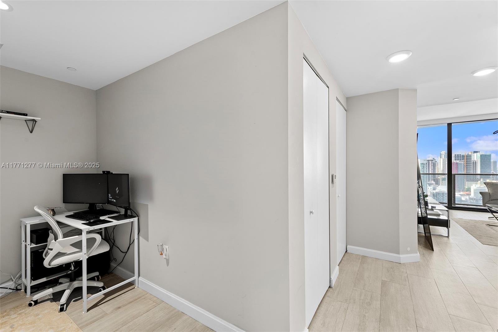 55 Southwest 9th Street, Unit 3601 Miami, FL 33130 - Photo 28 of 38 a view of a workspace with furniture and wooden floor