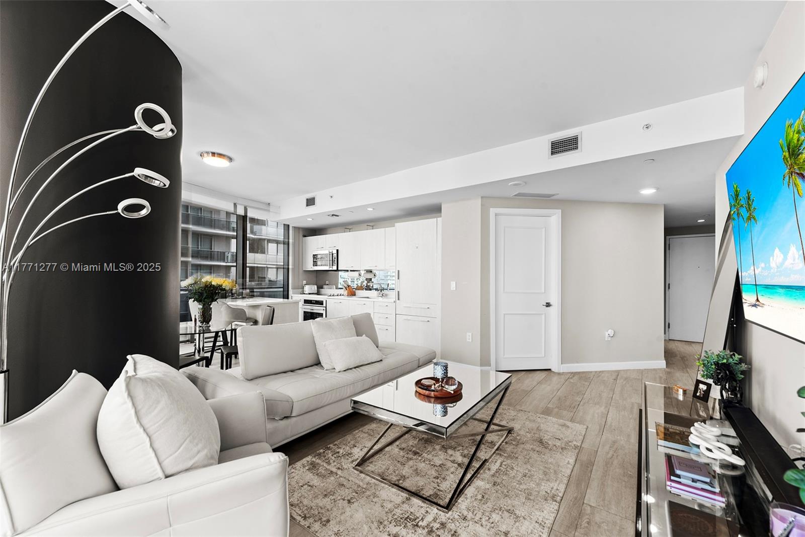 55 Southwest 9th Street, Unit 3601 Miami, FL 33130 - Photo 4 of 38 a living room with furniture and a couch