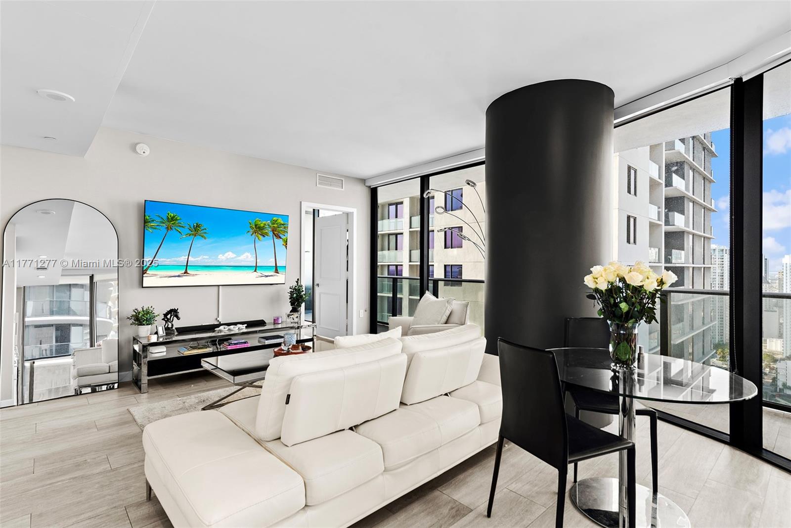 55 Southwest 9th Street, Unit 3601 Miami, FL 33130 - Photo 5 of 38 a living room with furniture and a flat screen tv