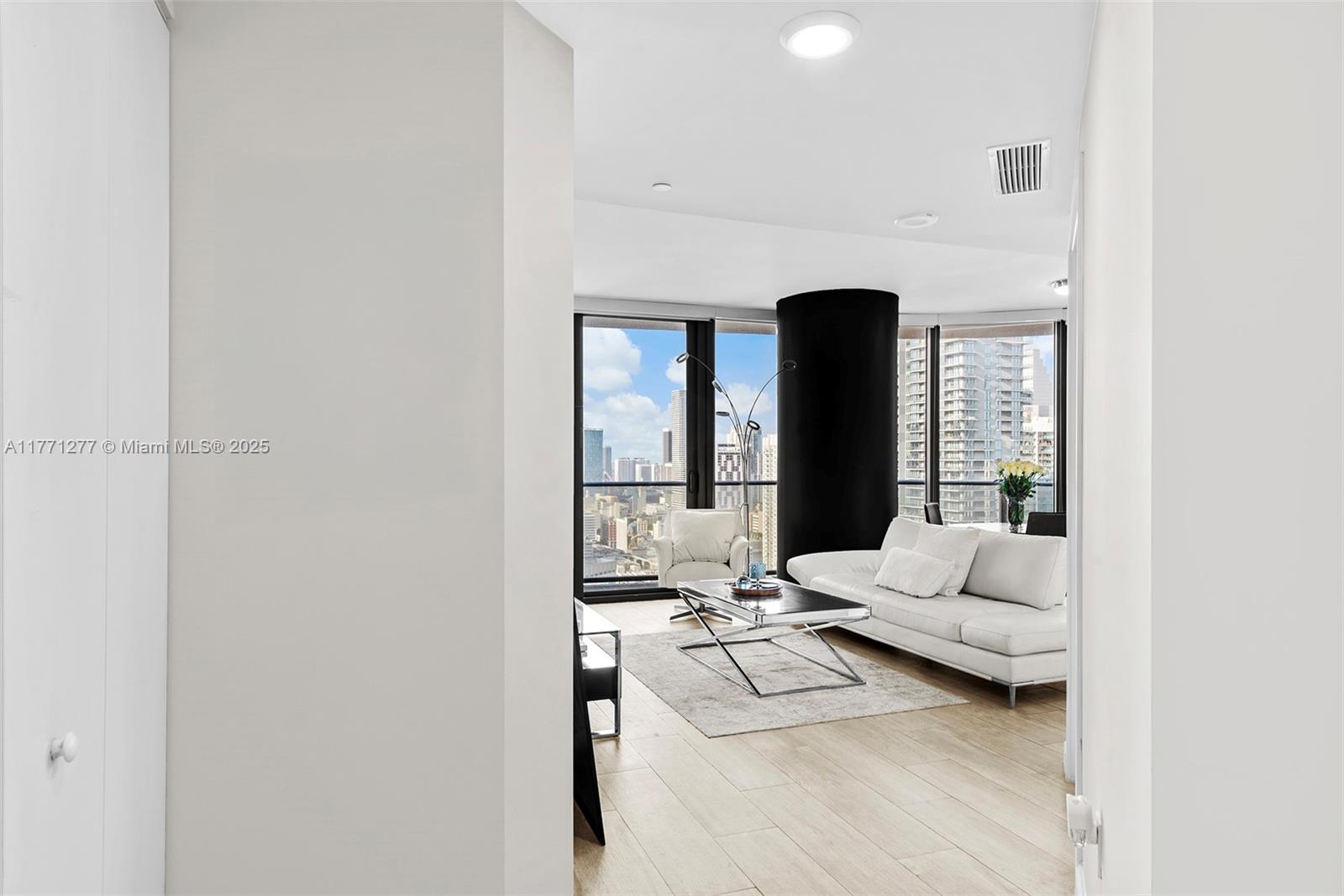 55 Southwest 9th Street, Unit 3601 Miami, FL 33130 - Photo 8 of 38 a living room with furniture and a mirror