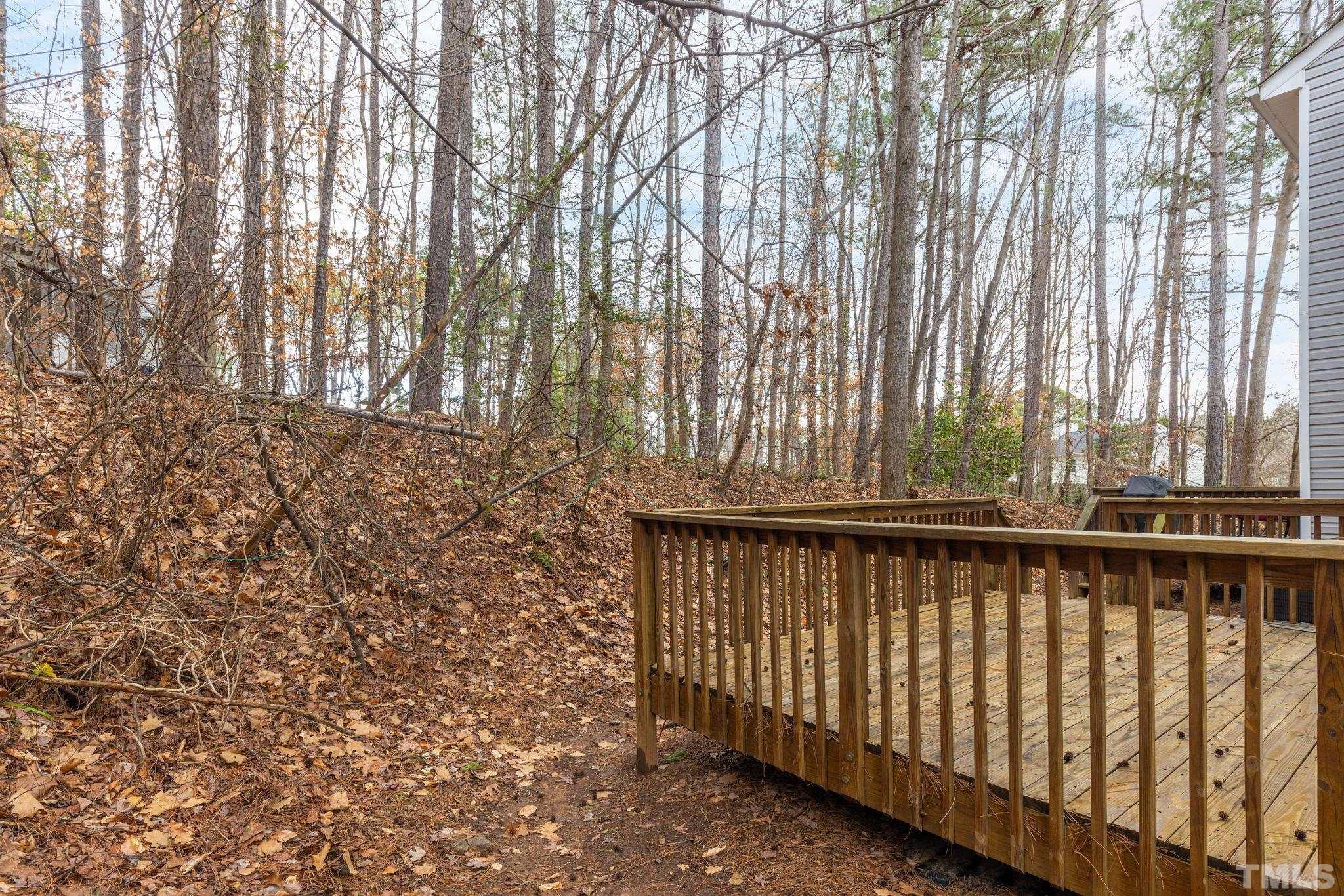 4313 Timberwood Drive Raleigh, NC 27612 - Photo 13 of 28 a view of outdoor space with deck and trees