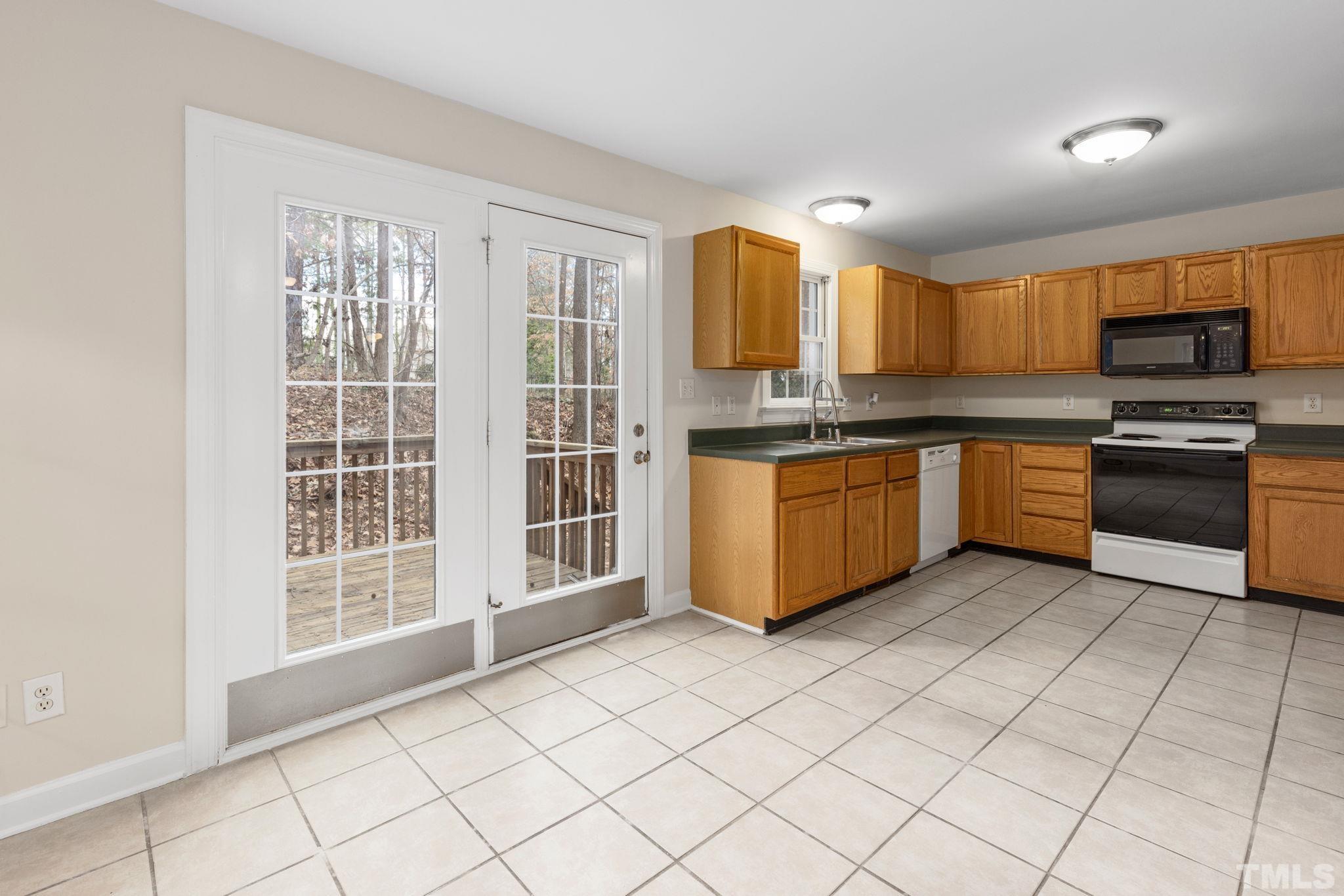 4313 Timberwood Drive Raleigh, NC 27612 - Photo 16 of 28 a kitchen with stainless steel appliances granite countertop a stove and a sink