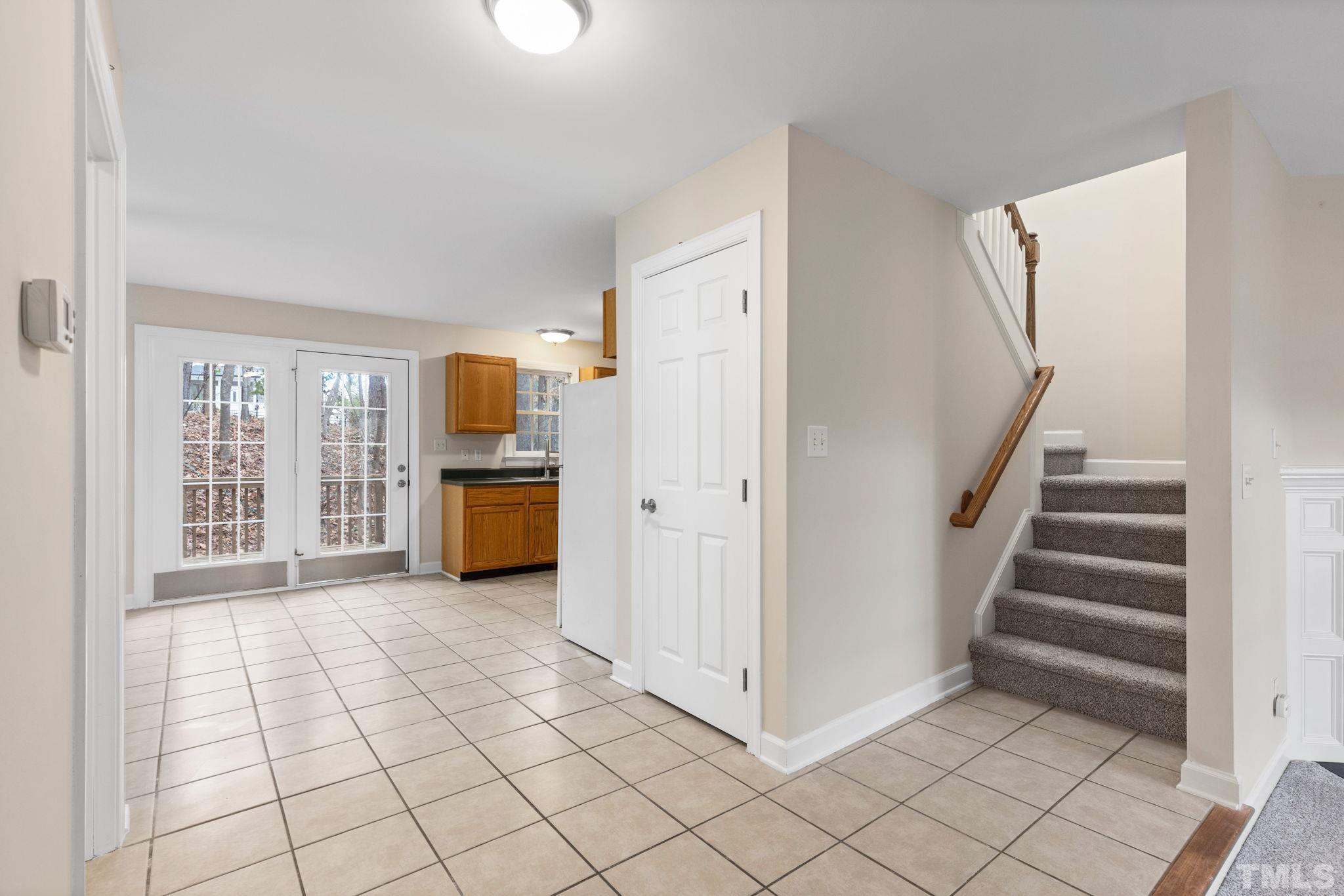 4313 Timberwood Drive Raleigh, NC 27612 - Photo 19 of 28 a view of a kitchen with utility room and stairs