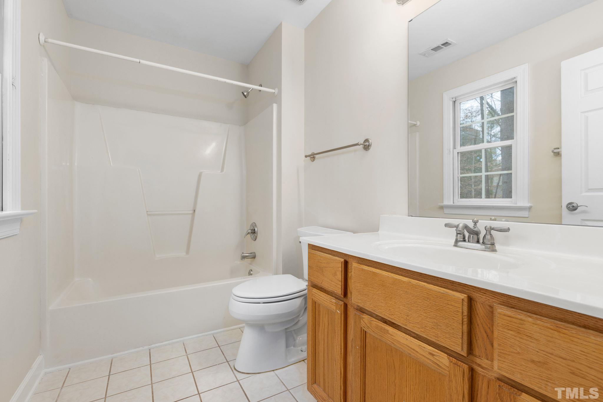 4313 Timberwood Drive Raleigh, NC 27612 - Photo 22 of 28 a bathroom with a sink toilet and shower