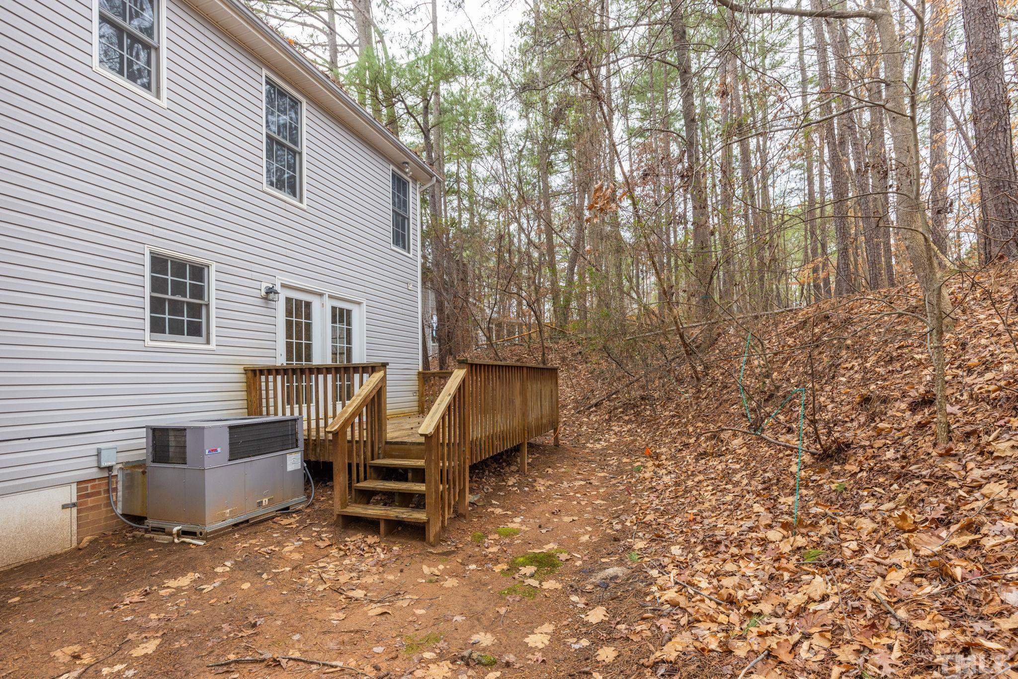 4313 Timberwood Drive Raleigh, NC 27612 - Photo 28 of 28 a wooden bench sitting in front of a house