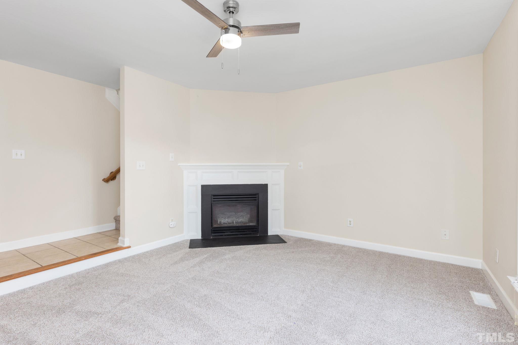 4313 Timberwood Drive Raleigh, NC 27612 - Photo 6 of 28 a view of an empty room with a fireplace