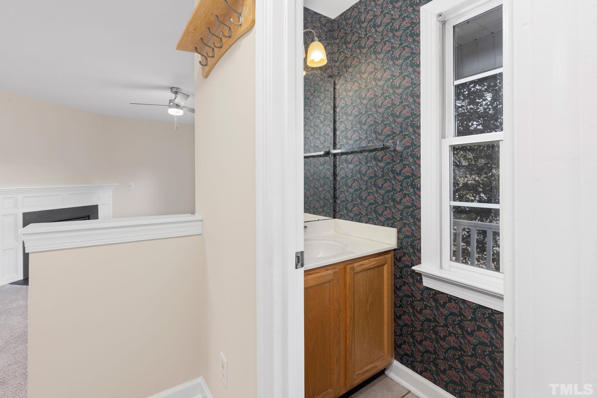 4313 Timberwood Drive Raleigh, NC 27612 - Photo 8 of 28 a bathroom with a granite countertop sink a toilet and shower