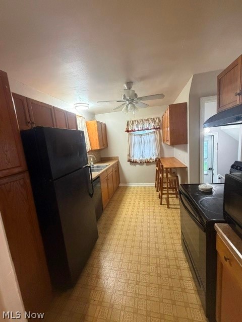 1388 Cranover Road Lyndhurst, OH 44124 - Photo 14 of 35 Galley kitchen with wood-finish cabinetry, patterned flooring, and a ceiling fan with integrated lighting