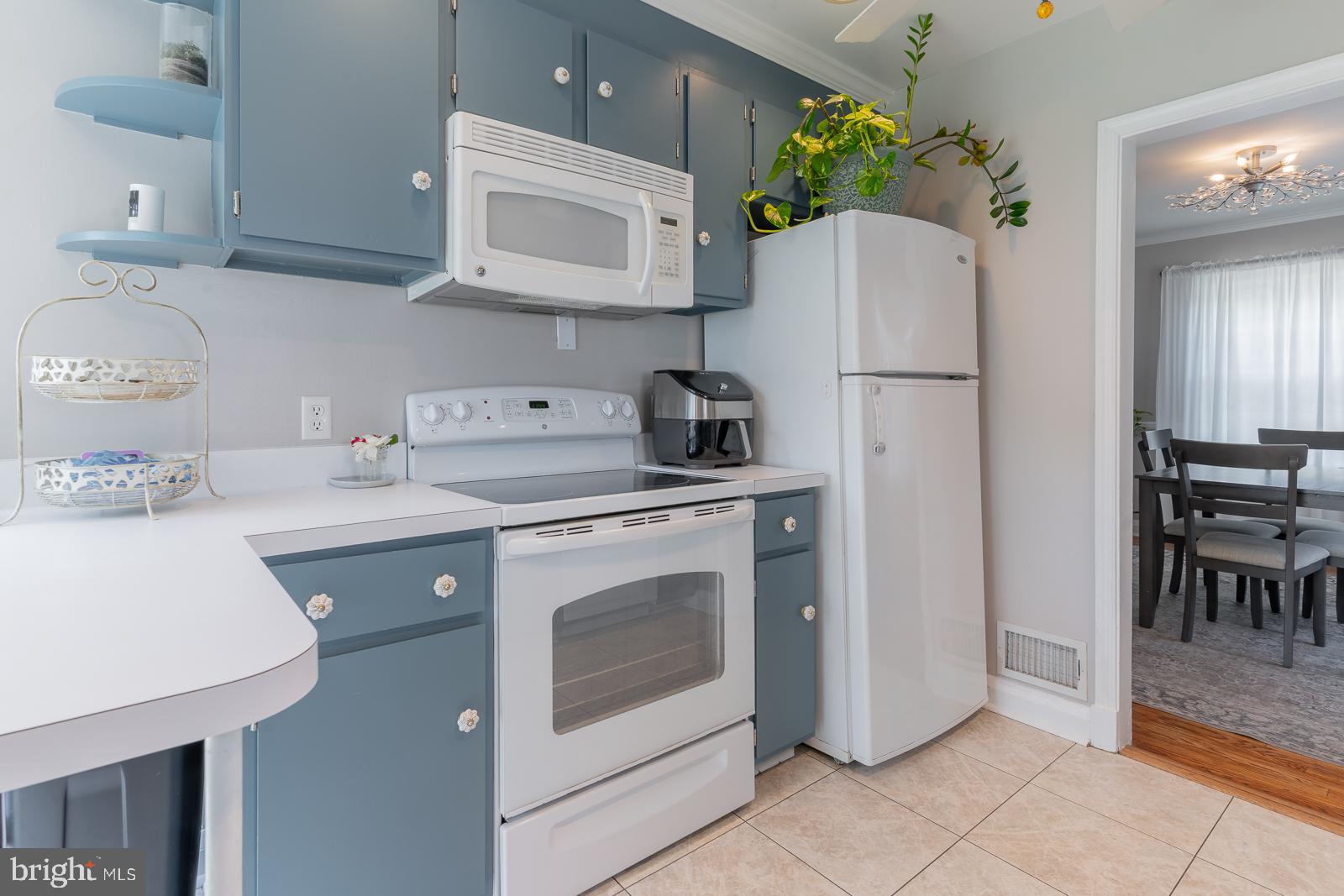 223 Sycamore Road Linthicum Heights, MD 21090 - Photo 11 of 32 a kitchen with a white stove top oven and refrigerator