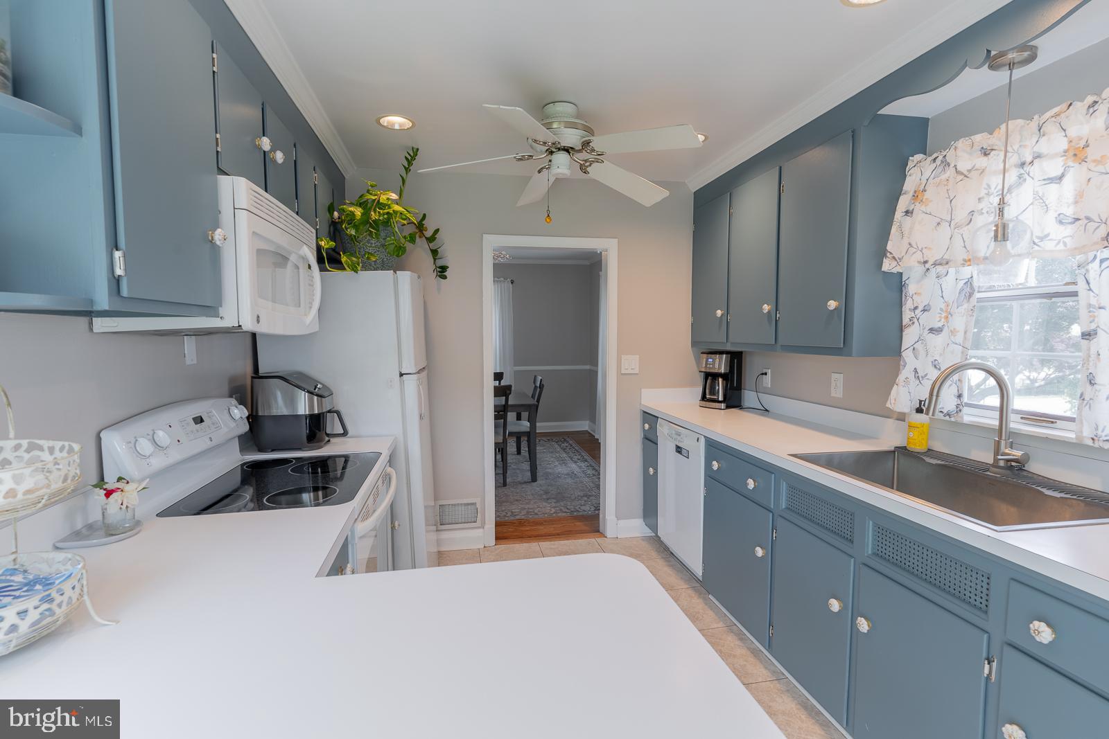 223 Sycamore Road Linthicum Heights, MD 21090 - Photo 13 of 32 a kitchen with a sink stove and cabinets