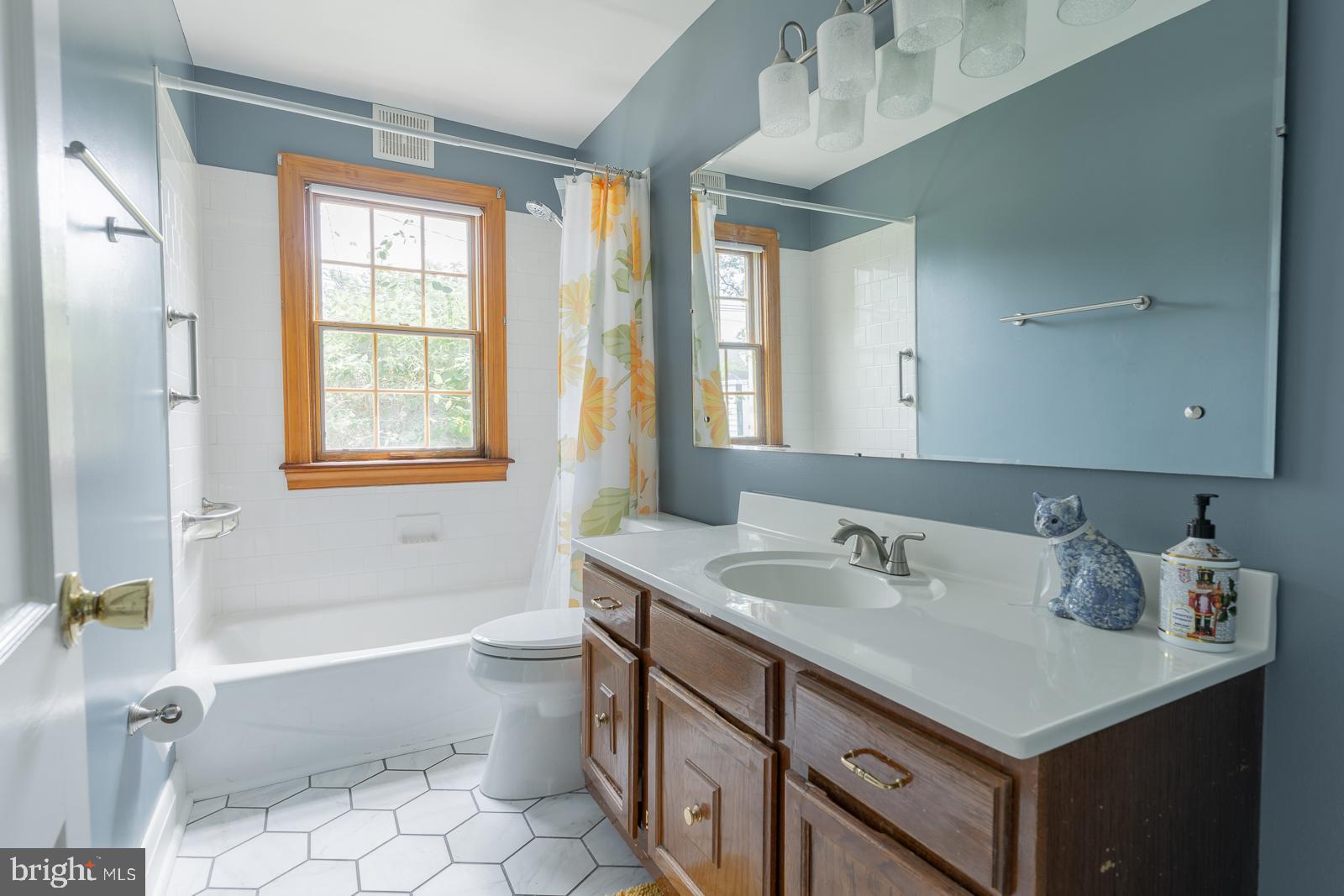 223 Sycamore Road Linthicum Heights, MD 21090 - Photo 14 of 32 a bathroom with a sink double vanity granite tub toilet and next to a window