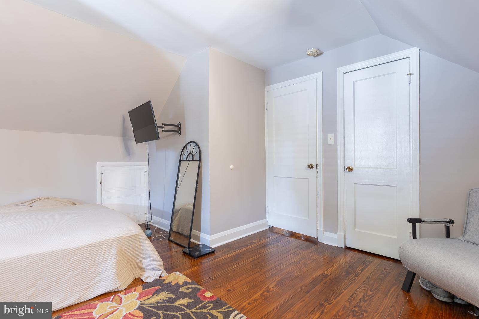 223 Sycamore Road Linthicum Heights, MD 21090 - Photo 18 of 32 a room with a bed and flat screen tv