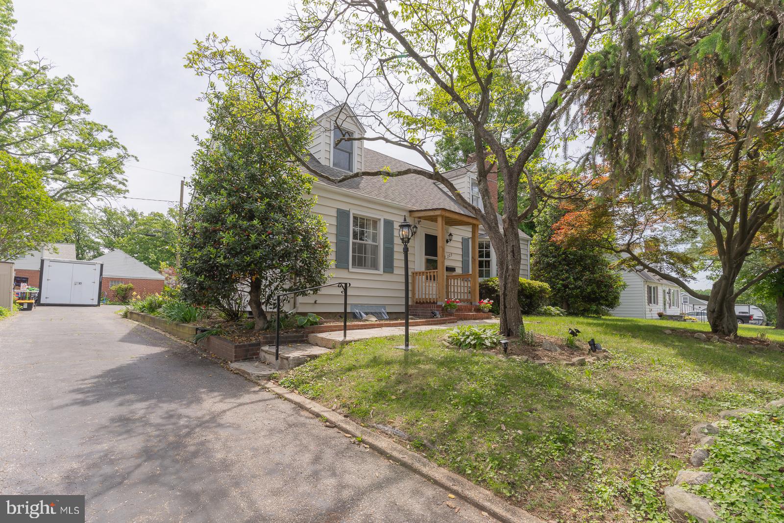 223 Sycamore Road Linthicum Heights, MD 21090 - Photo 2 of 32 a white house in middle of the forest