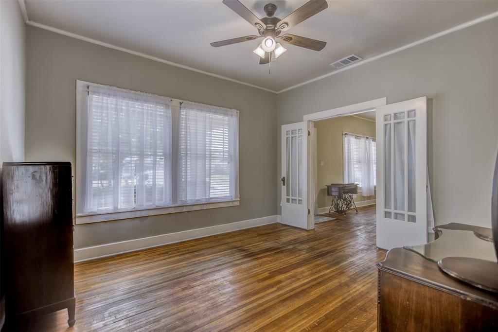 2220 West Rosedale Street South Fort Worth, TX 76110 - Photo 12 of 33 a view of livingroom with hardwood floor and a ceiling fan
