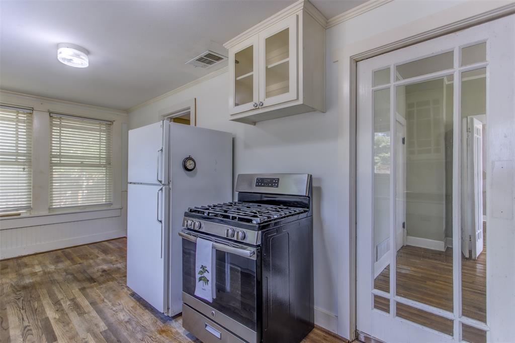 2220 West Rosedale Street South Fort Worth, TX 76110 - Photo 21 of 33 a kitchen that has a stove and a refrigerator