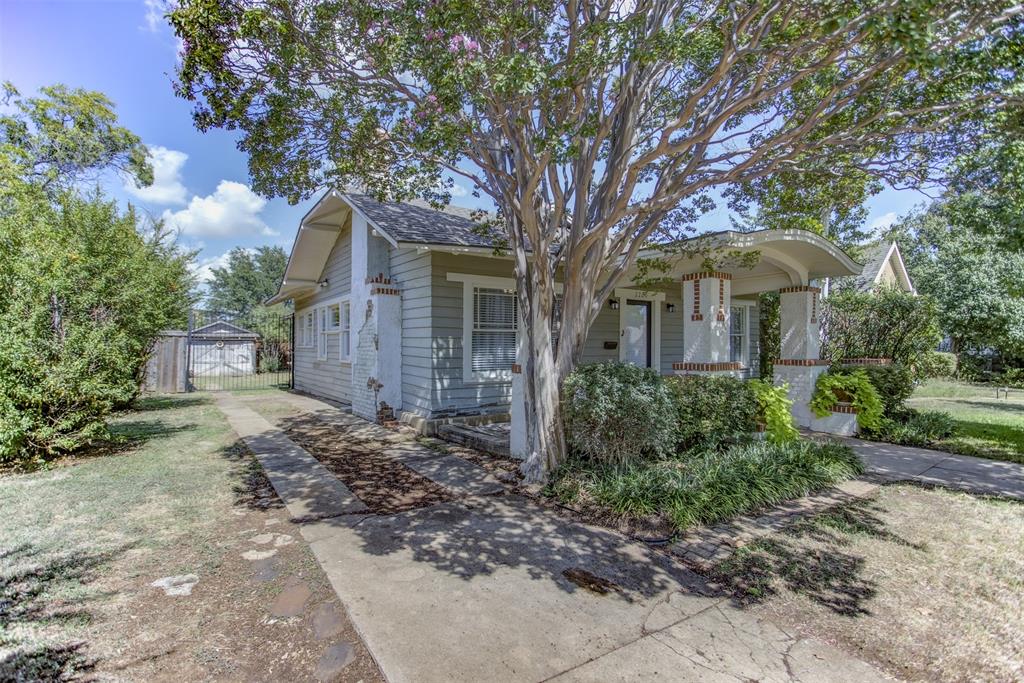 2220 West Rosedale Street South Fort Worth, TX 76110 - Photo 32 of 33 a front view of a house with garden