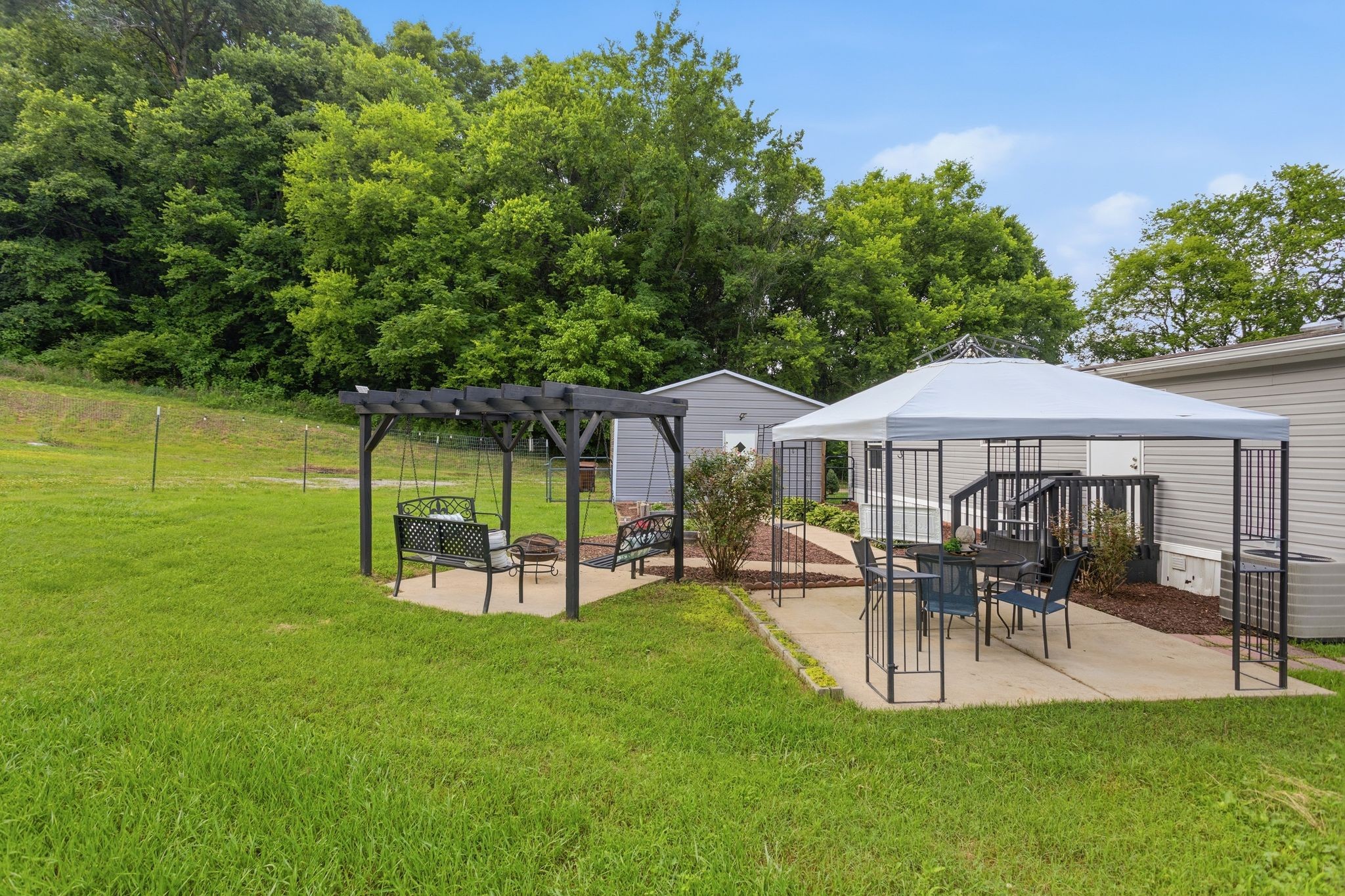 3204 Grizzly Road Culleoka, TN 38451 - Photo 21 of 25 a view of a patio with table and chairs under an umbrella