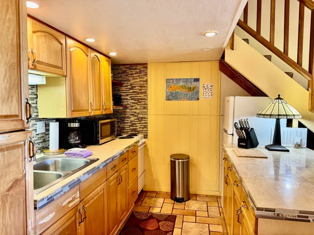 a kitchen with stainless steel appliances kitchen island granite countertop a sink and cabinets