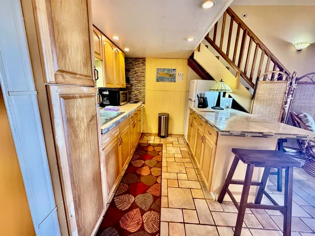 a kitchen with cabinets and wooden floor