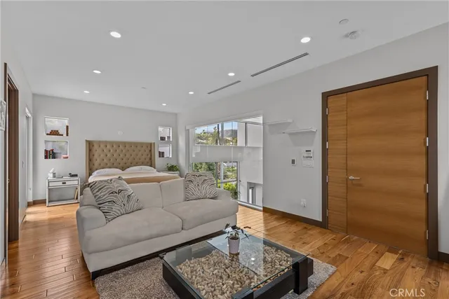 a bedroom with a large bed and a couch