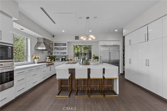 a view of a hallway with wooden floor and windows