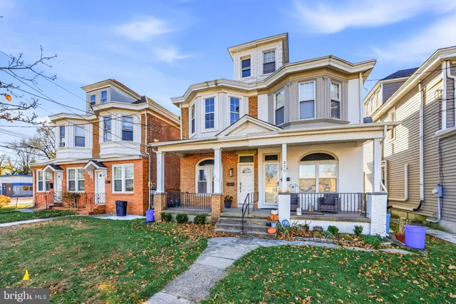 a front view of a residential apartment building with a yard