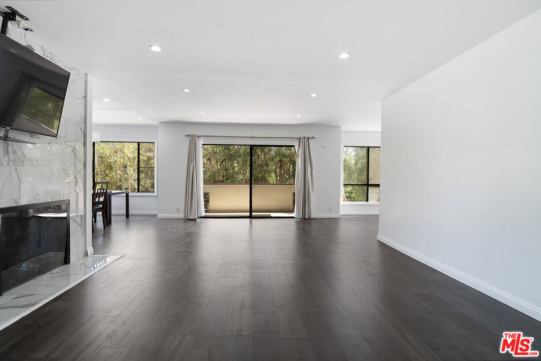 853 Le Doux Road, Unit 201 Los Angeles, CA 90035 - Photo 2 of 36 an empty room with wooden floor and windows