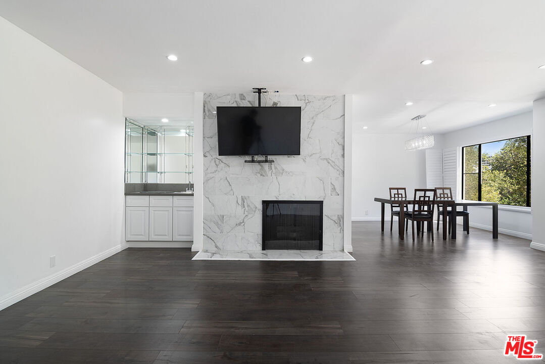 853 Le Doux Road, Unit 201 Los Angeles, CA 90035 - Photo 3 of 36 a living room with furniture a fireplace and a flat screen tv