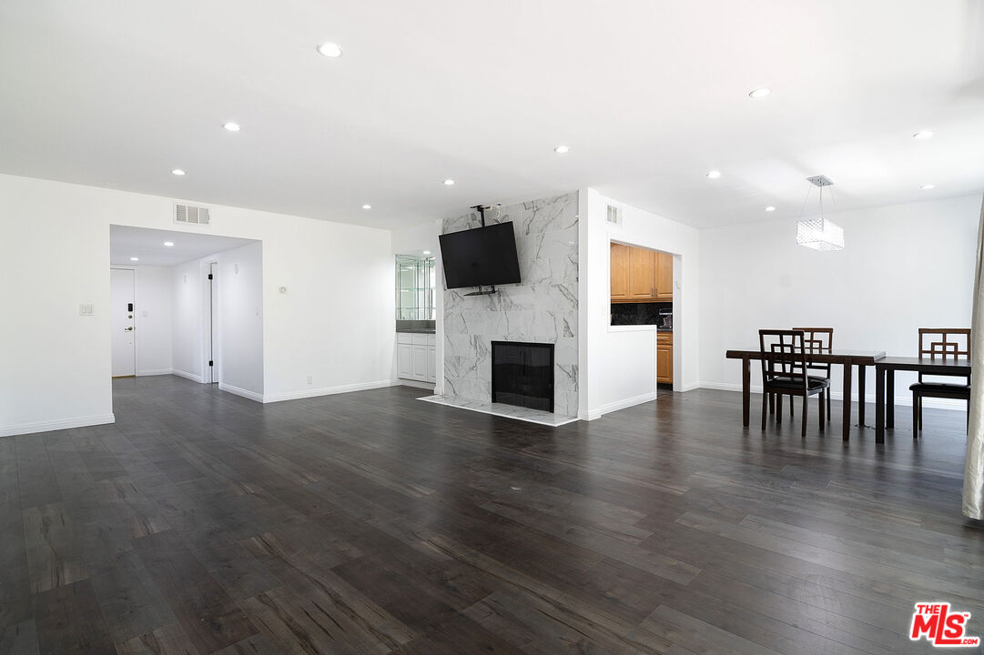 853 Le Doux Road, Unit 201 Los Angeles, CA 90035 - Photo 4 of 36 an open kitchen with furniture and wooden floor