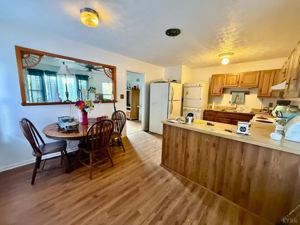 a view of a dining room with furniture and a chandelier