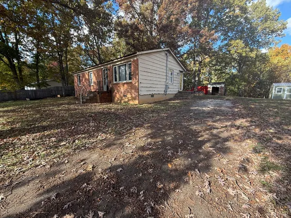 a view of backyard of house with trees