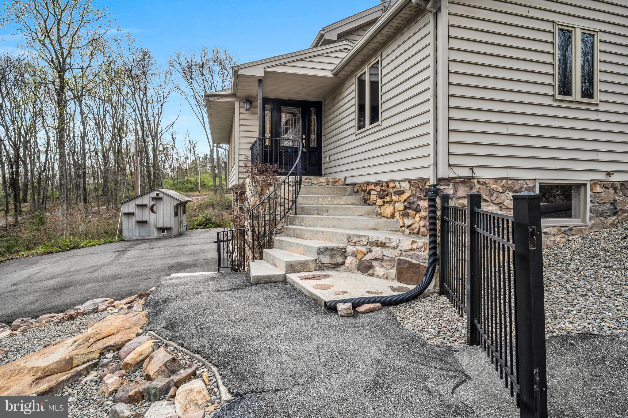 125 Bobcat Road Carlisle, PA 17015 - Photo 52 of 83 a view of a patio with table and chairs with wooden fence