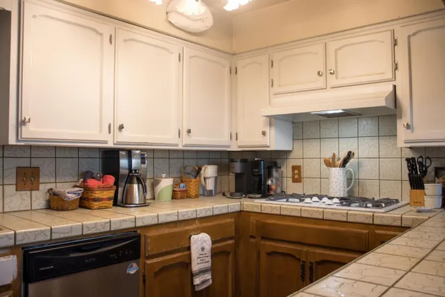 a kitchen with stainless steel appliances granite countertop a sink and cabinets