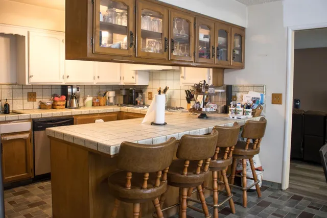 a dining table with chairs and cabinets