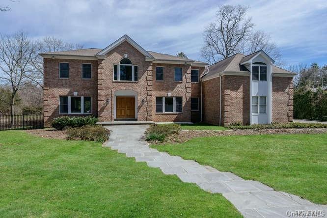 a front view of a house with a yard