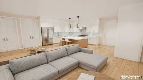 a living room with furniture and kitchen view
