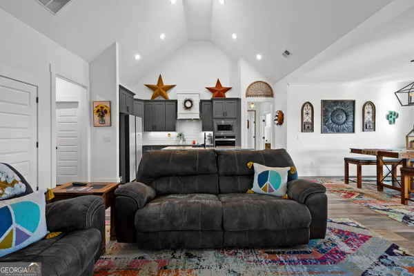 a kitchen with stainless steel appliances a stove a sink a refrigerator and cabinets