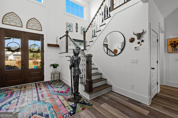 a view of an entryway with wooden floor