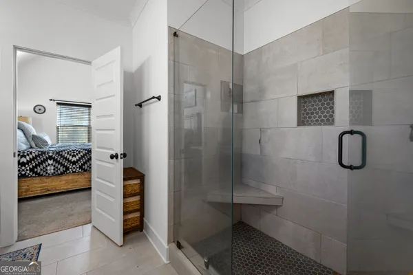 a bathroom with double vanity and a mirror