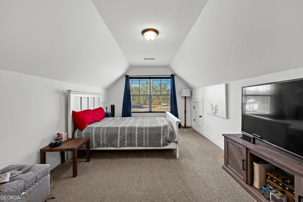 a bathroom with a bathtub and next to a window