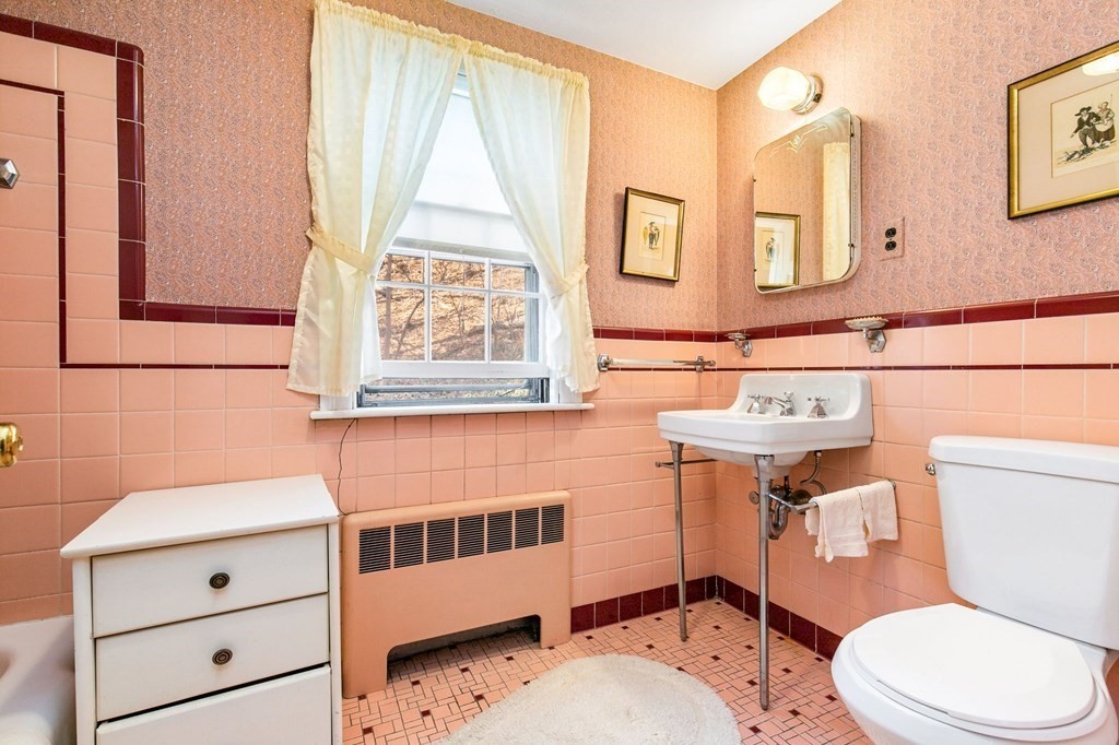 177 Varick Road Newton, MA 02468 - Photo 11 of 29 a bathroom with a sink a toilet a mirror and shower
