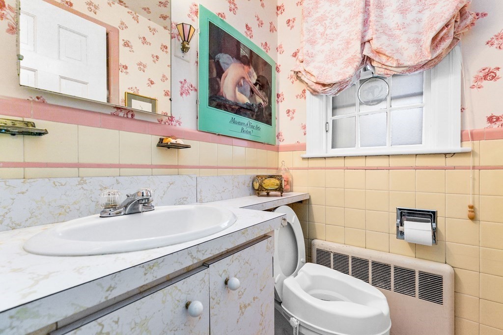 177 Varick Road Newton, MA 02468 - Photo 14 of 29 a bathroom with a sink and a toilet