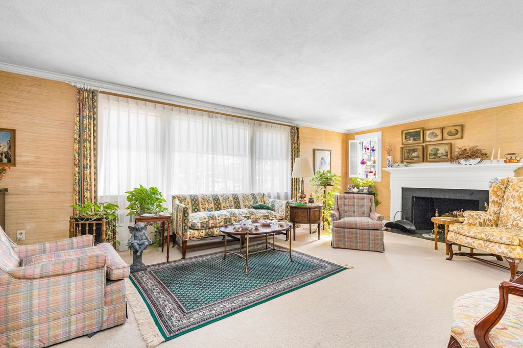 177 Varick Road Newton, MA 02468 - Photo 15 of 29 a living room with furniture fireplace and a table