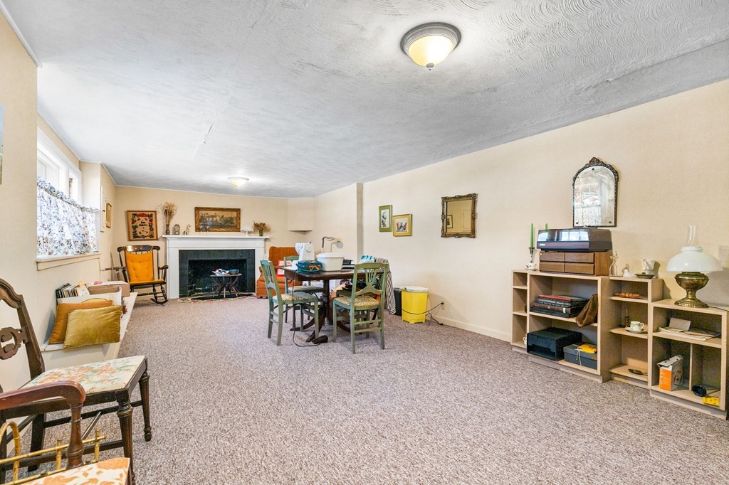177 Varick Road Newton, MA 02468 - Photo 18 of 29 a view of a livingroom with furniture and a fireplace