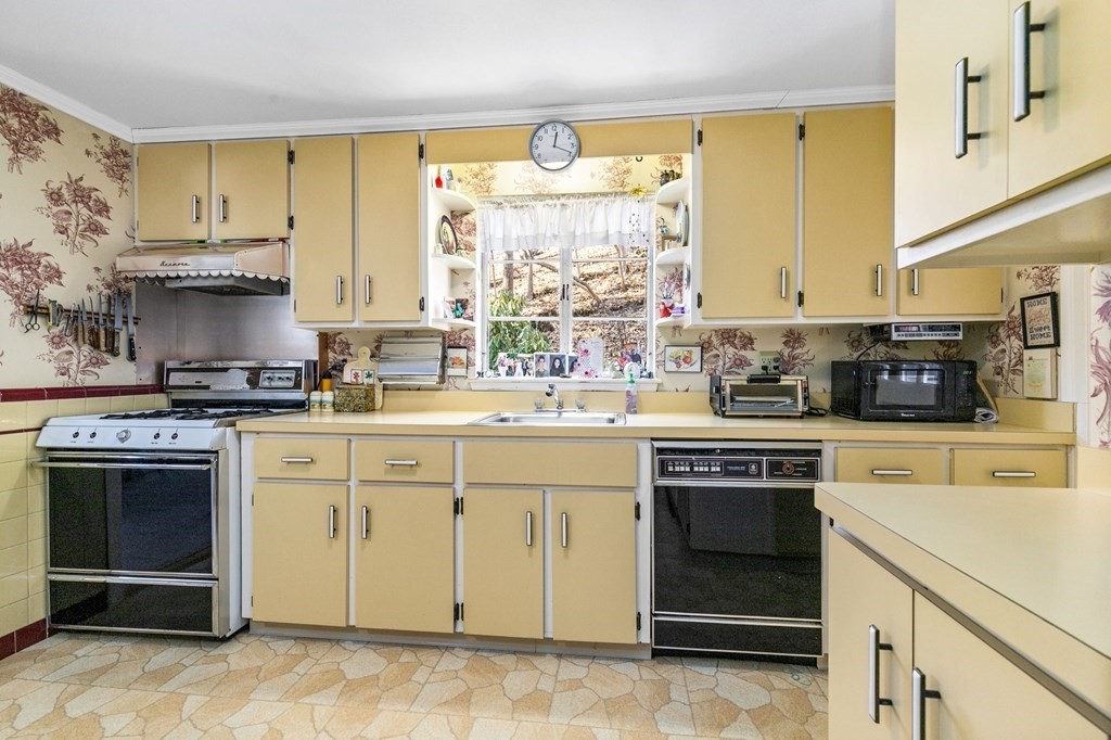 177 Varick Road Newton, MA 02468 - Photo 2 of 29 a kitchen with stainless steel appliances a stove sink and cabinets